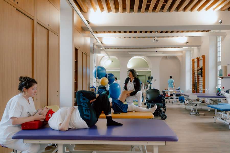 Vue d'ensemble de la salle de rééducation du CRPT, patients et soignants en séance